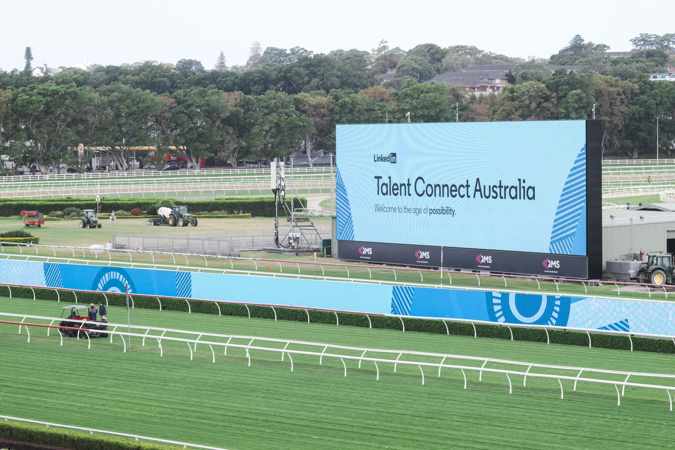 A large digital billboard in the interior of a racecourse